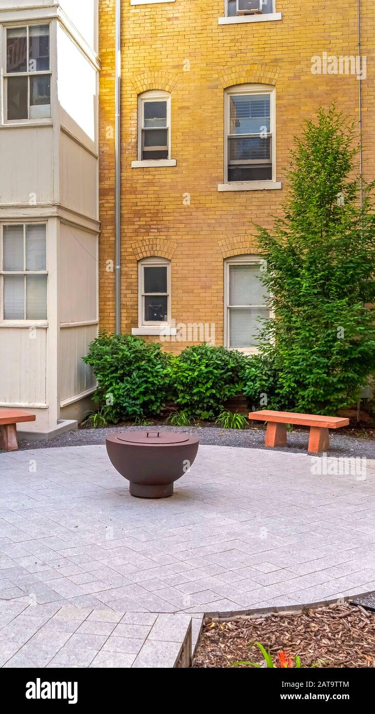 Vertical Stone Benches Around A Fire Pit Outside A Residential