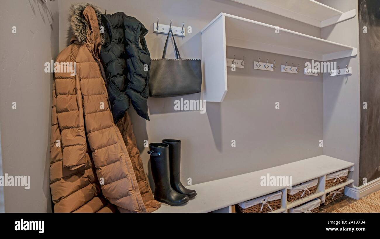 Panorama frame Walk in closet with clothes bag and shoes on the built in shelves and hangers Stock Photo