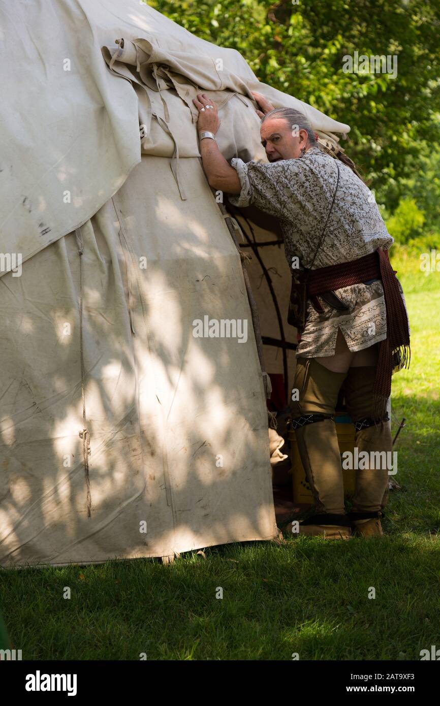 A reenactor at Historic Old Fort Wayne checks inside a tent. Stock Photo