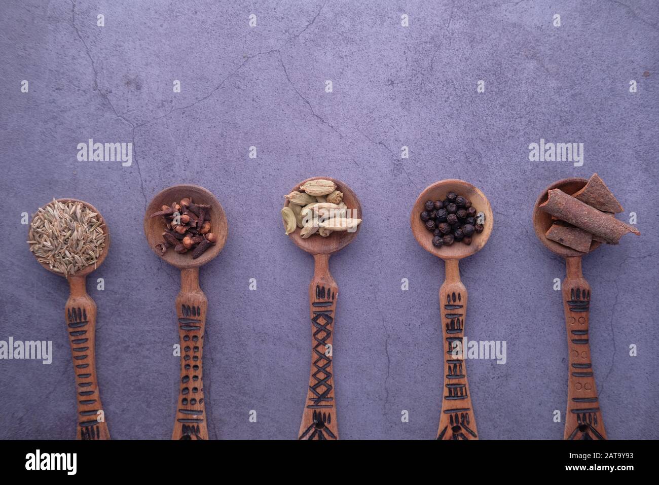 various herbs and spices on spoon on table  Stock Photo