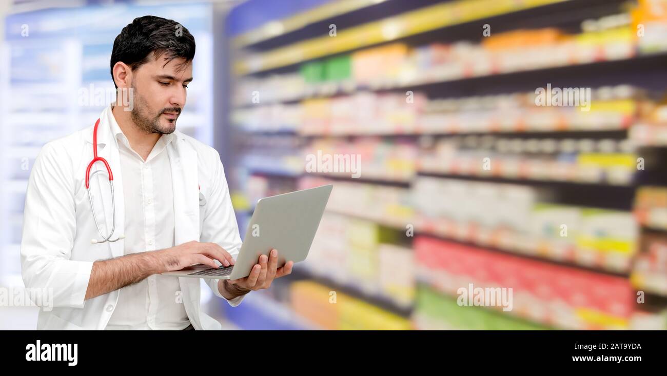 Pharmacist or doctor using laptop computer at the pharmacy room