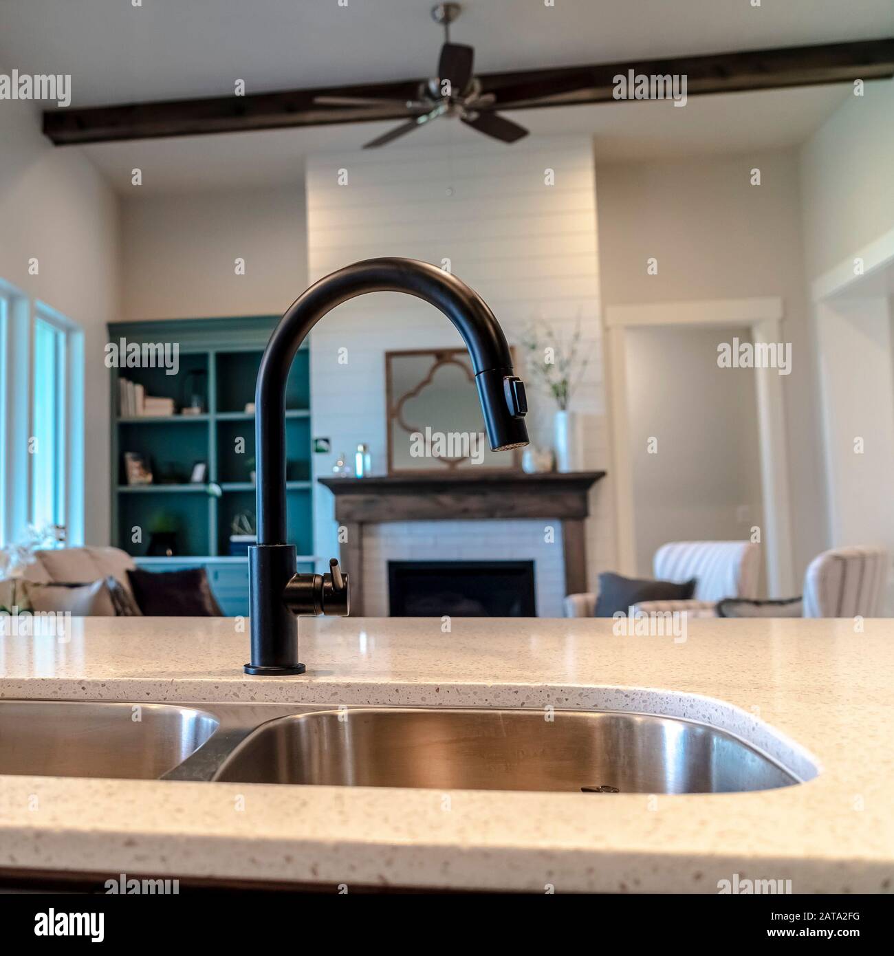 Photo Square Kitchen Island With Double Basin Undermount Sink Black Faucet And Fruit Basket Stock Photo Alamy