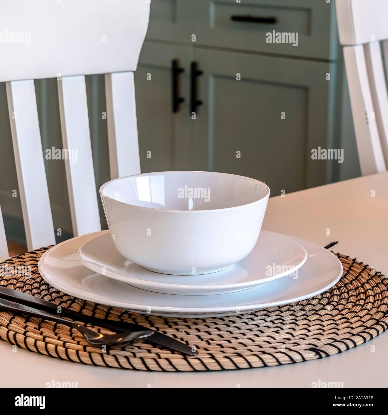 Square Dining Table Setting Of Home Against Chairs Wooden Floor And Kitchen Cabinets Stock Photo Alamy