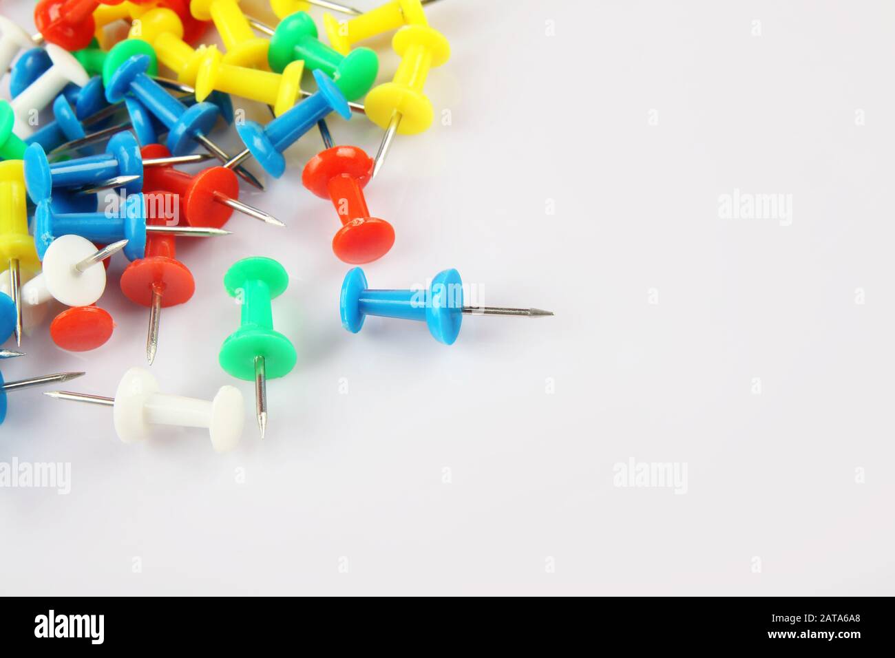 Metal push pins on white background Stock Photo - Alamy