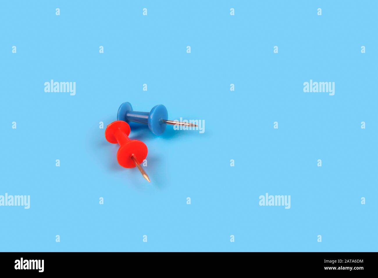 Metal push pins on Blue background Stock Photo - Alamy