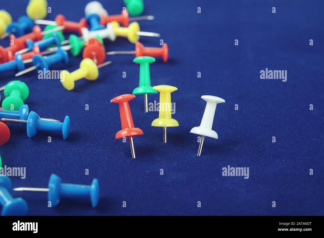 Metal push pins on Blue background Stock Photo - Alamy