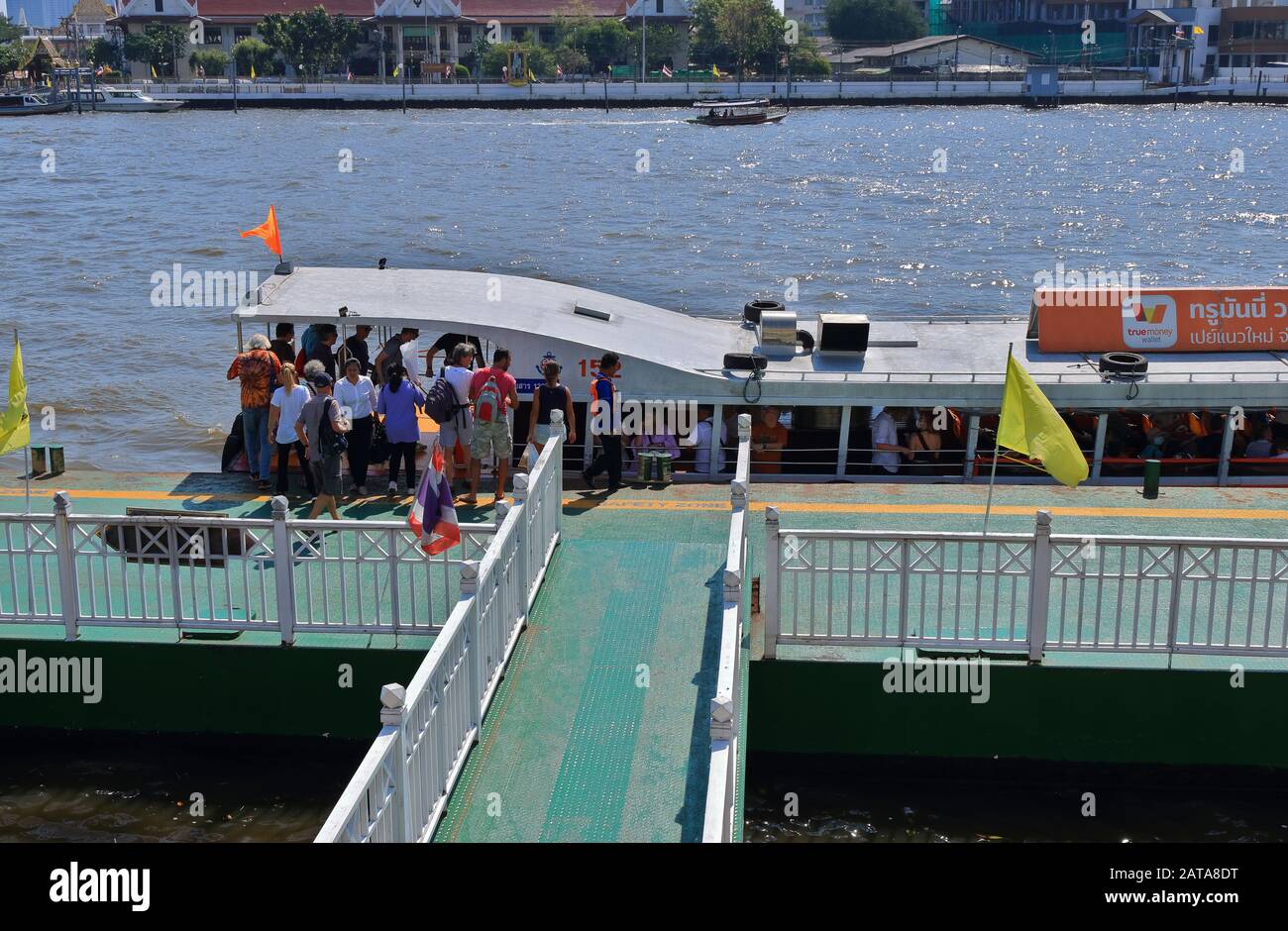 Bangkok, Thailand- January 28 2020: Group of tourists getting on and off the tourist boat at Yodpiman pier on Chao Phraya river Stock Photo