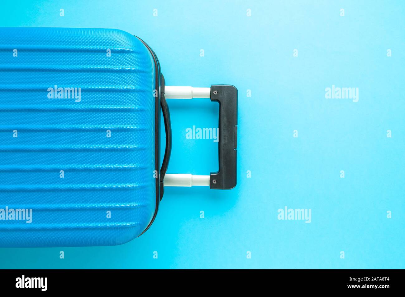 Suitcase on pastel blue background minimal creative travel concept