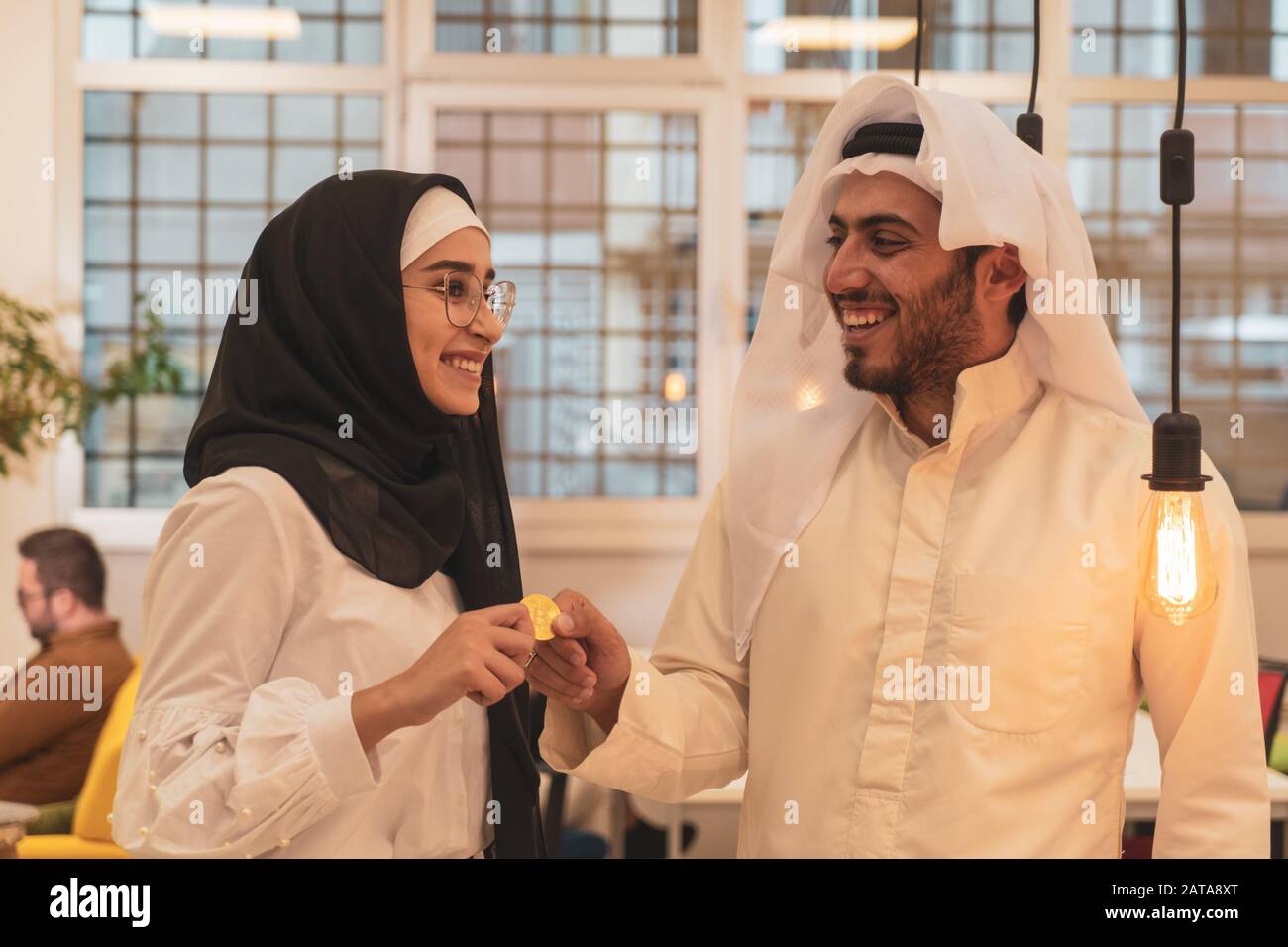 Muslim hijab woman share bitcoin with arabian businessman. Cryptocurrency  concept Stock Photo - Alamy