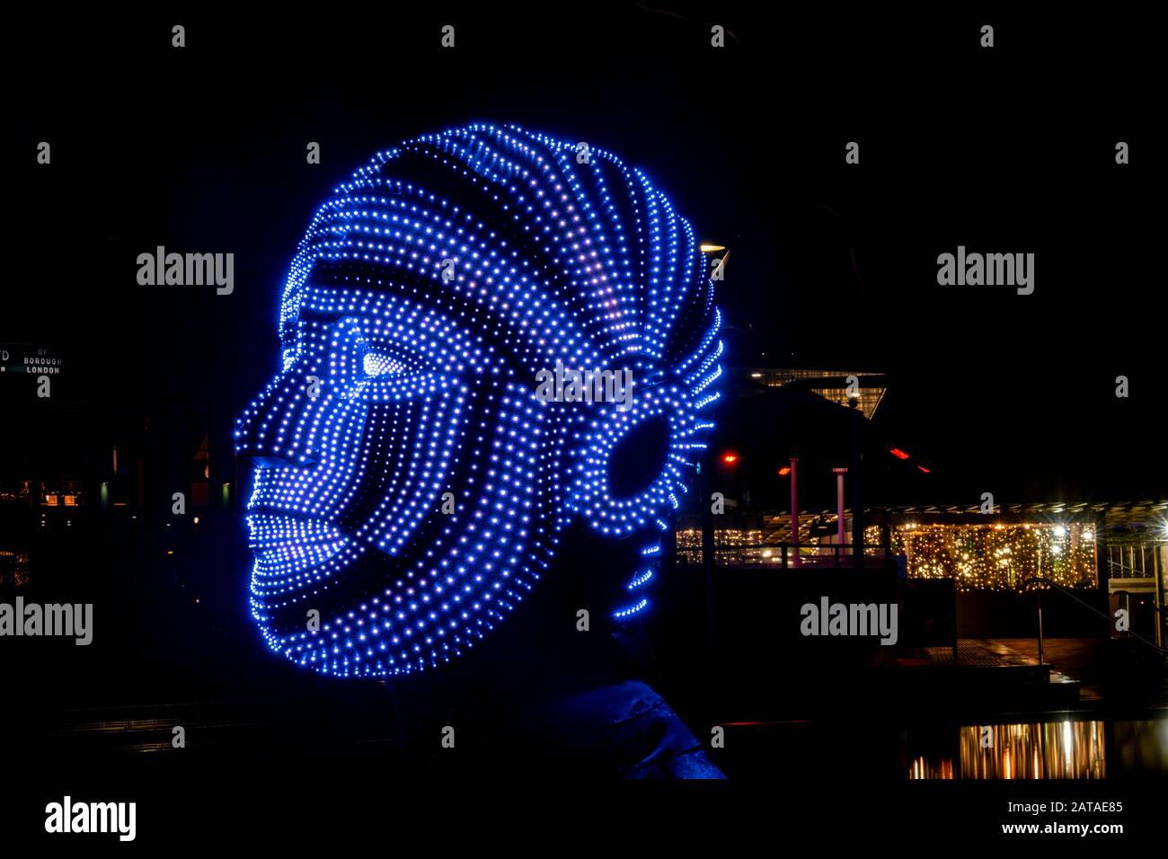 A view of two heads made up of lights entitled 'Talking Heads' by Victor Vicsek at West Circus Village at Battersea Power Station in London Stock Photo