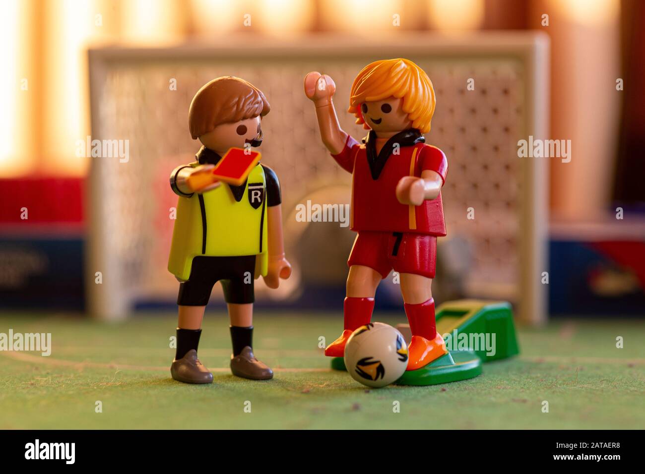 Playmobil referee figure showing red card to player Stock Photo