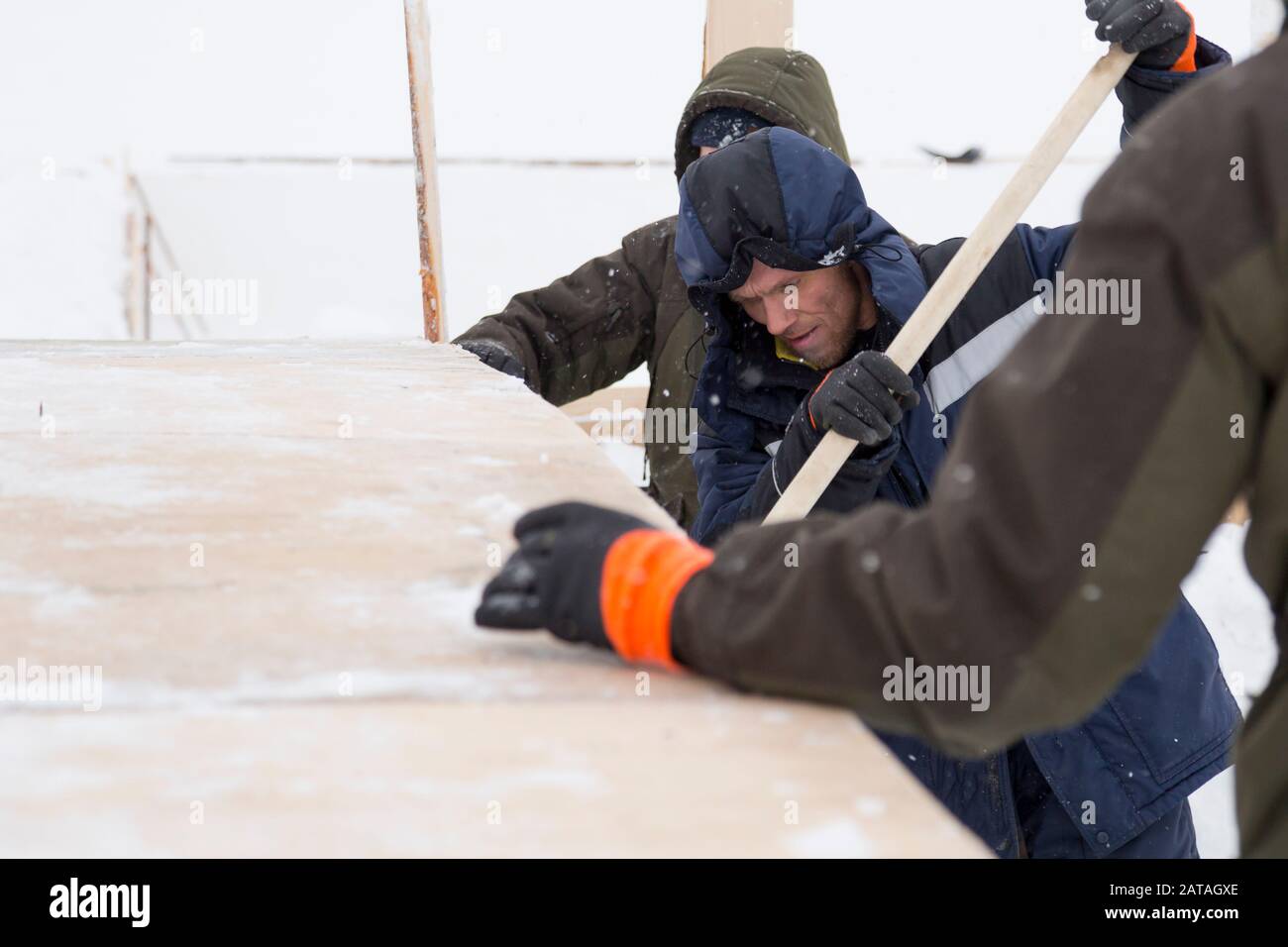 Two workers in overalls at a construction site Stock Photo