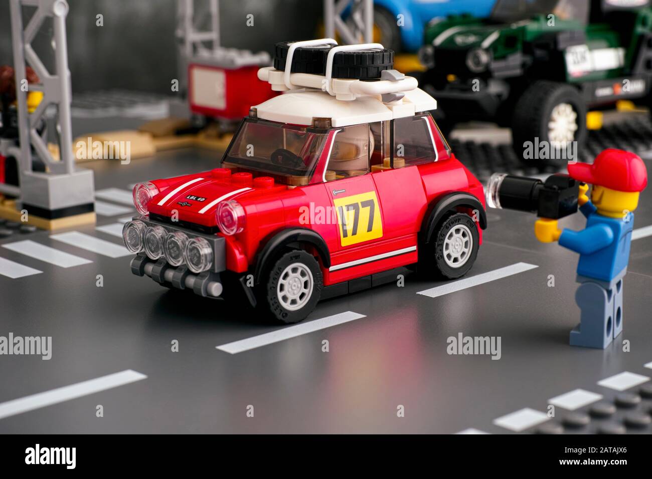 Tambov, Russian Federation - August 18, 2019 Lego man with camera taking a picture of 1967 Mini Cooper S Rally car by LEGO Speed Champions on road bas Stock Photo
