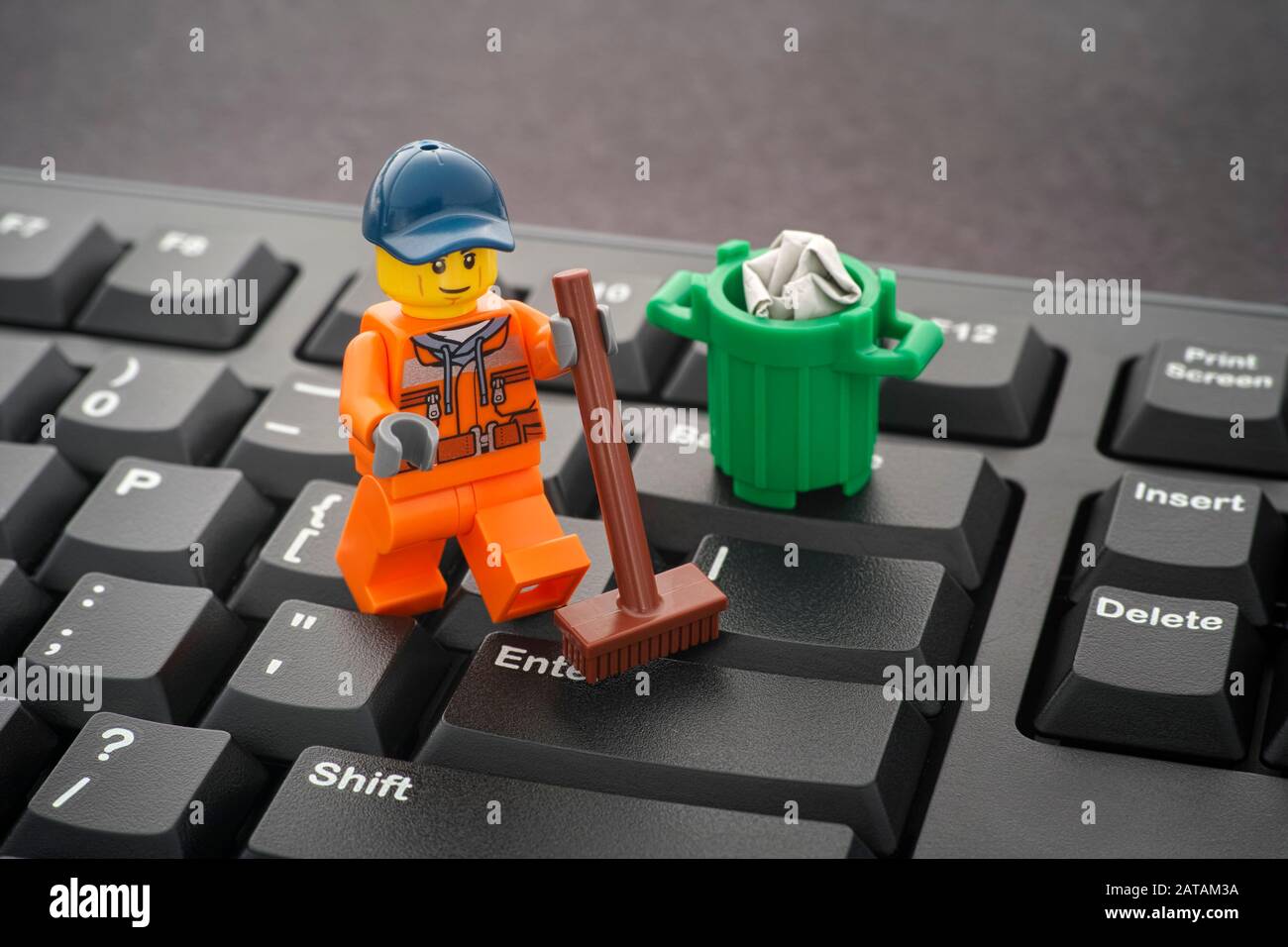 Tambov, Russian Federation - January 24, 2020 Lego minifigure cleaning keyboard with a broom. Stock Photo