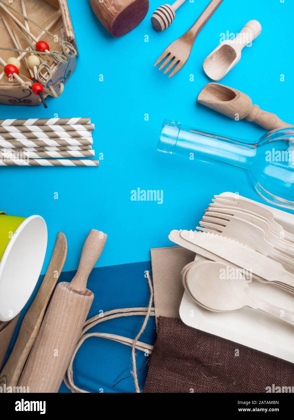 Zero waste concept. Textile brown eco bag, glass bottle, bamboo cutlery and kitchen utensils on blue background with Zero Waste concept. Eco friendly Stock Photo