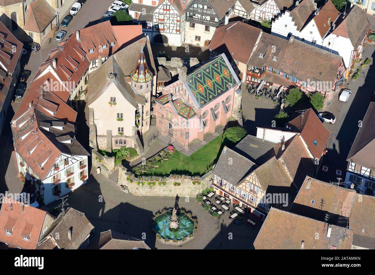 AERIAL VIEW. Castle of Saint-Léon-Pfalz and traditional half-timbered homes. Eguisheim, Haut-Rhin, Alsace, Grand Est, France. Stock Photo