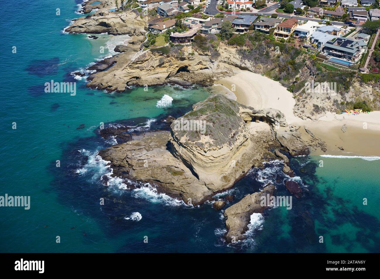 AERIAL VIEW. Dream homes on a jagged coastline overlooking the Pacific Ocean. Three Arches, Laguna Beach, Orange County, California, USA. Stock Photo