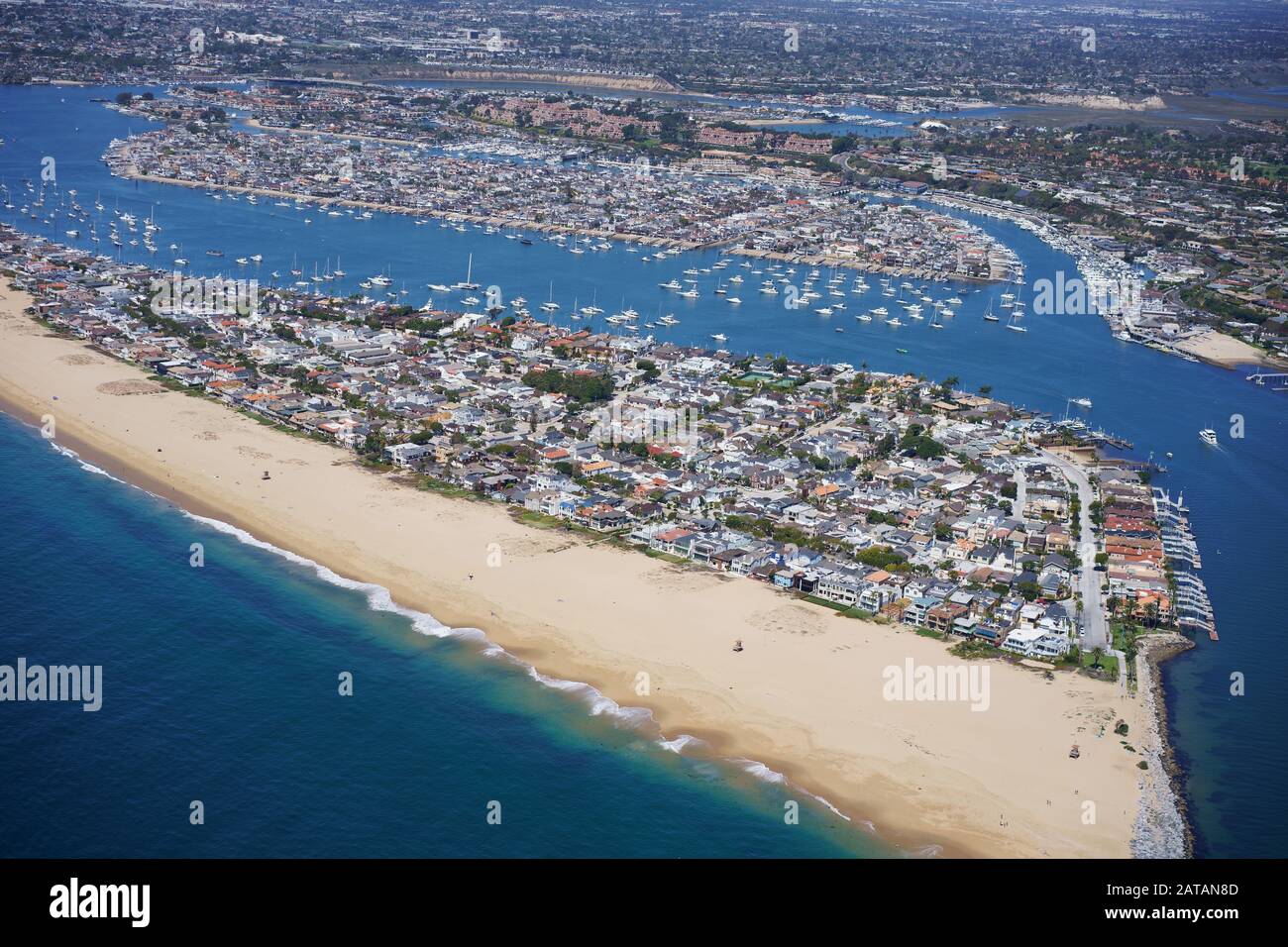 AERIAL VIEW. Balboa Peninsula with Lido Isle behind the main channel. Newport Beach, Orange County, California, USA. Stock Photo