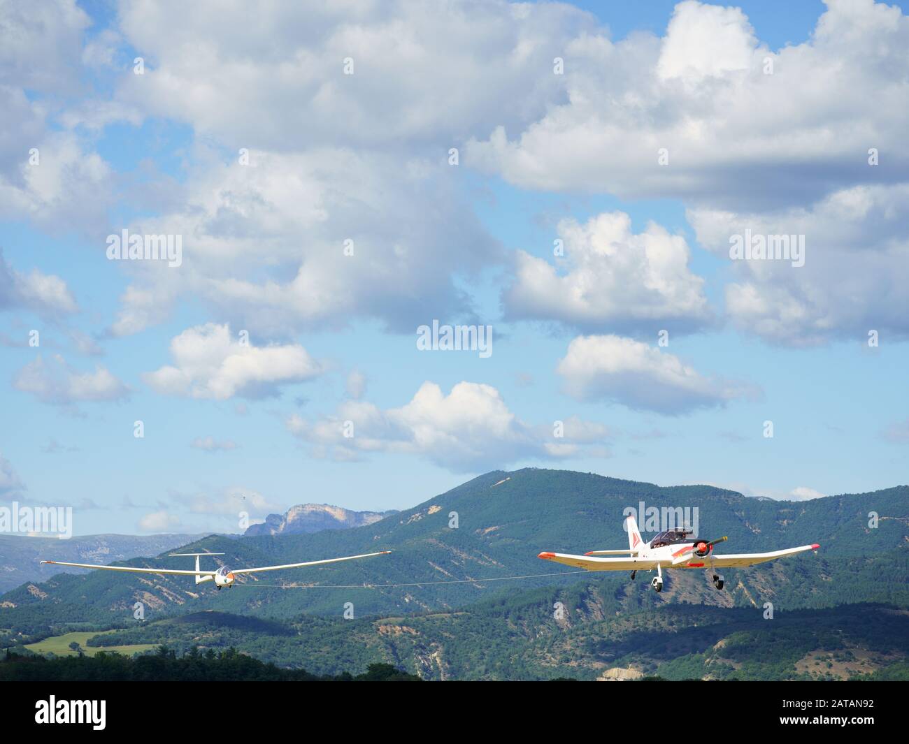 Sailplane aerotowed by a single-engine aircraft. Château-Arnoux Saint-Auban Airfield, Alpes de Haute-Provence, France. Stock Photo