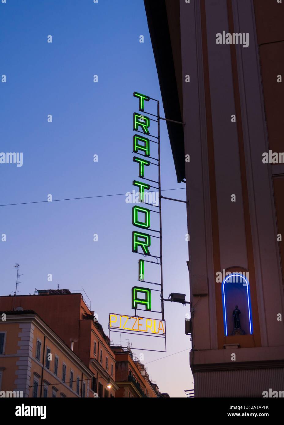 Rome, Italy - Jan 2, 2020: A green neon Trattoria sign on the side of a building in Rome, Italy. A Trattoria is an Italian eating establishment, less Stock Photo