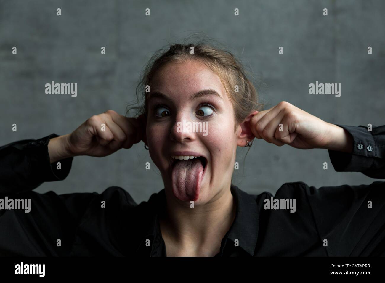 Portrait woman eyes crossed tongue hires stock photography and images