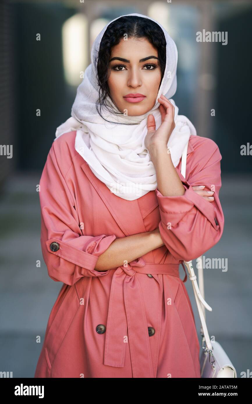 Young Arab woman wearing hijab headscarf walking in the city center. Stock Photo
