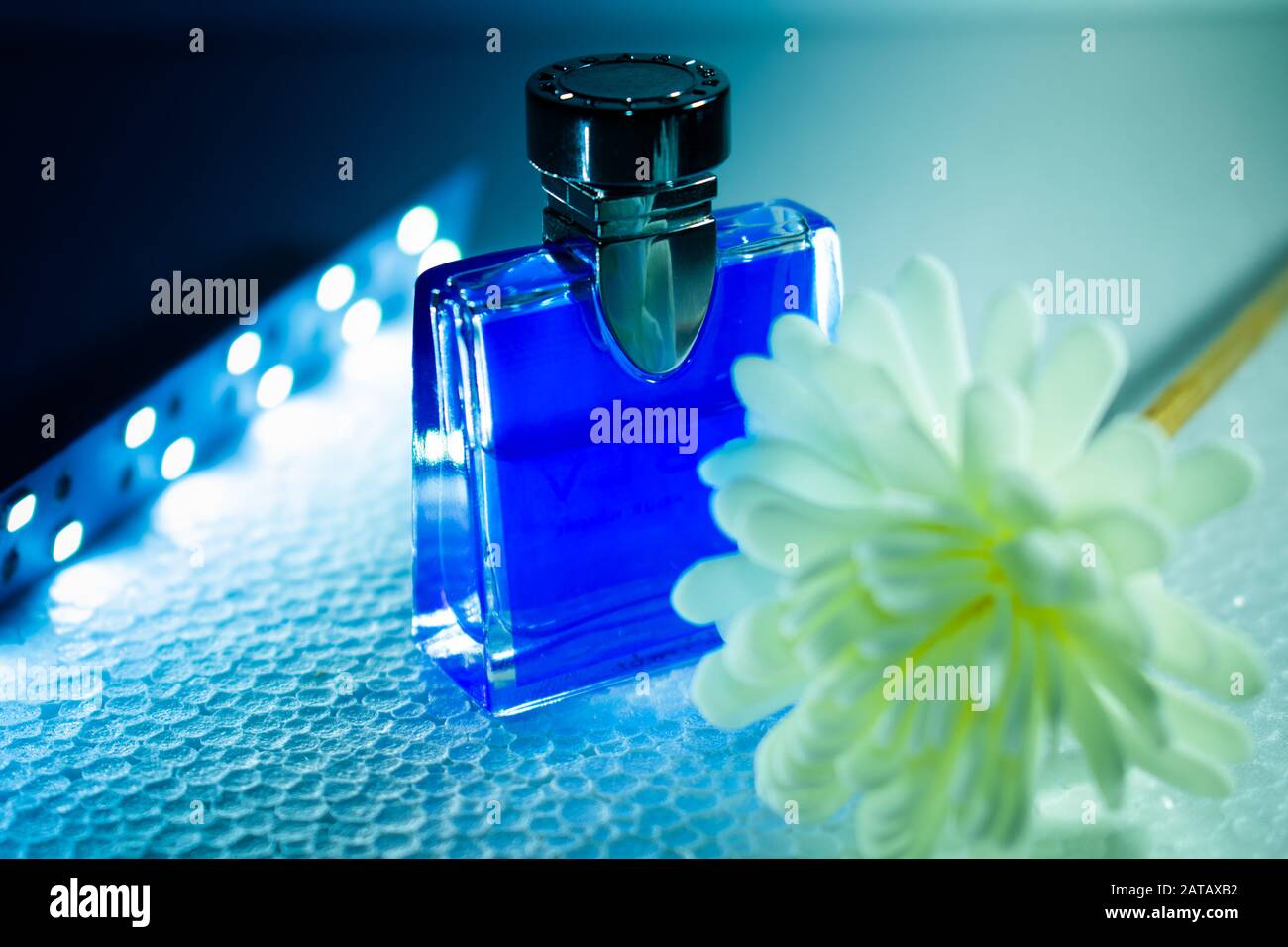 blue perfume bottle and flower Stock Photo Alamy