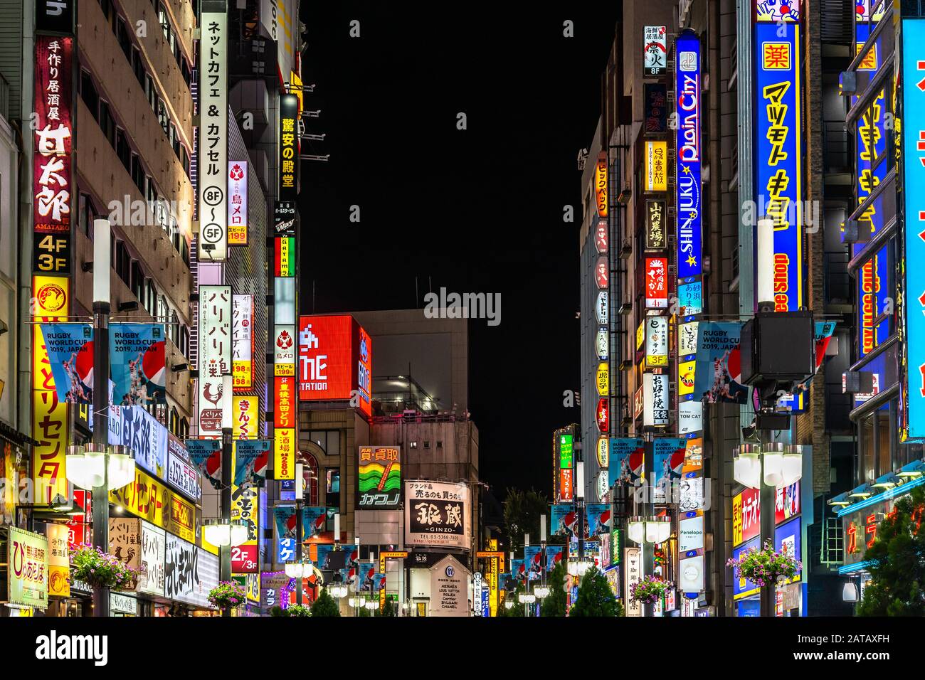 Tokyo, August 13, 2019 – Illuminated signs and billboards at night line along Central Road in Kabukicho, Shinjuku district Stock Photo
