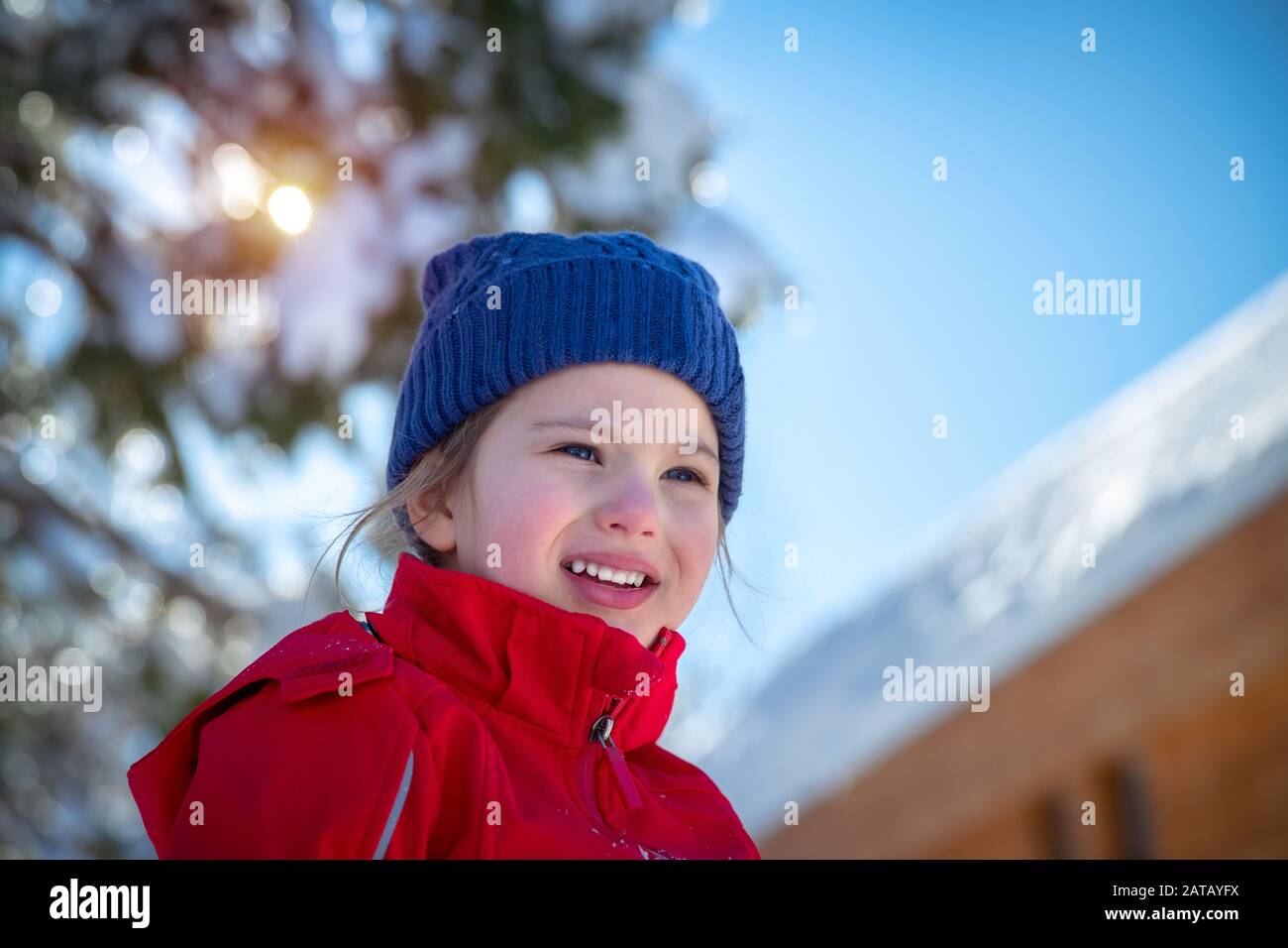 Portrait of a cute little girl having fun outdoors, cheerful child enjoying sunny winter day, happy winter holidays Stock Photo