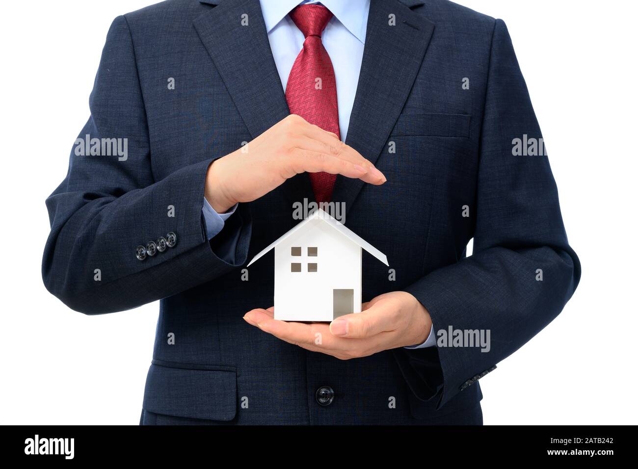 Businessman with house model on hand. Real estate concept Stock Photo ...