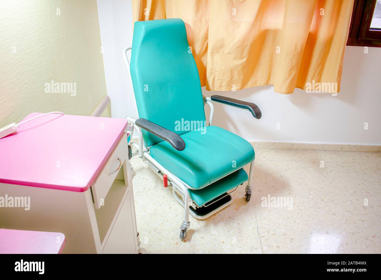 Hospital armchair convertible into a bed located in a hospital room to accompany hospitalized patients Stock Photo