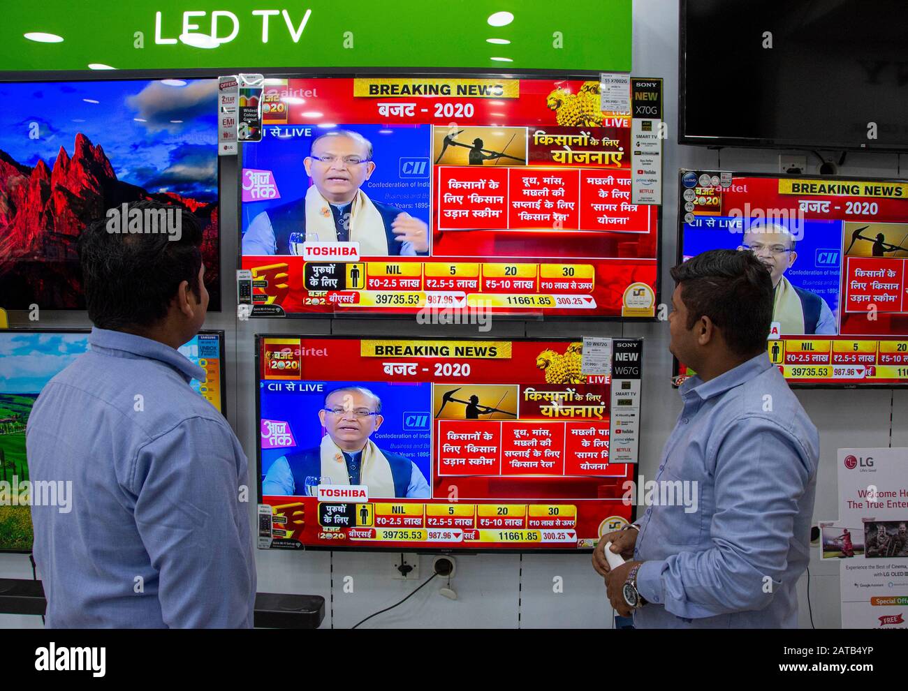 People watching budget news on a Television screen after budget 2020 announcement in Delhi. Stock Photo