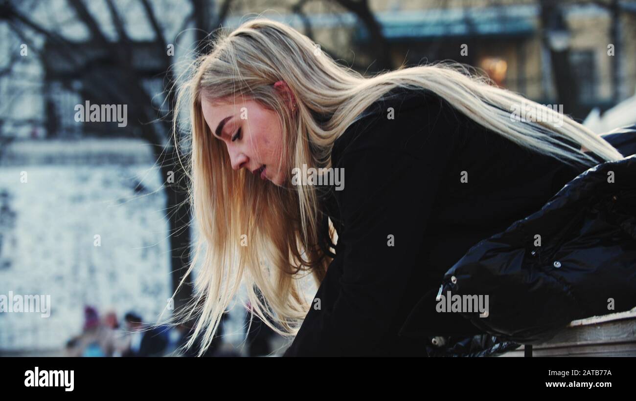 A young attractive woman with blond hair tie up her figure skates Stock Photo