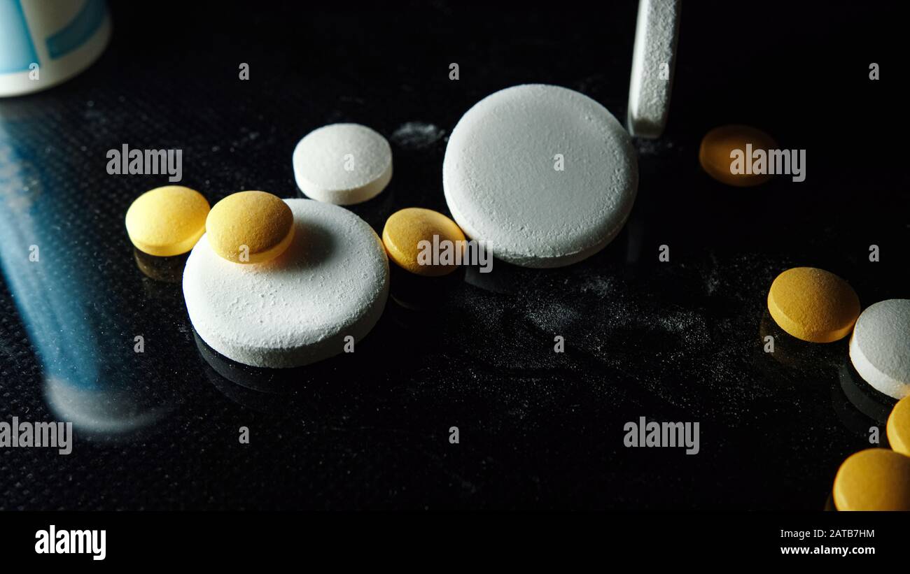 Pharmaceutical and medicine concept on black background. Medical pills
