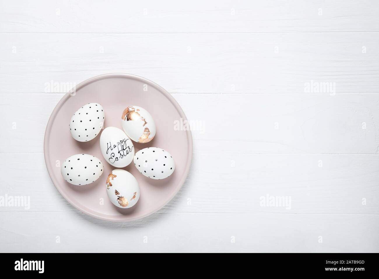 Easter eggs on a pink plate. Place for text Stock Photo