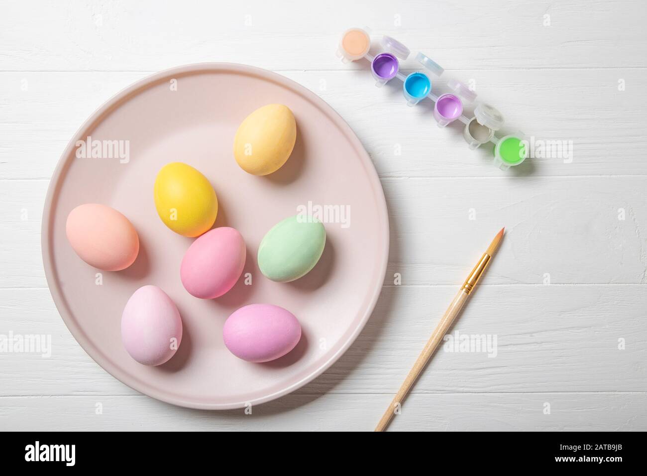 Multi-colored Easter eggs and paint brush. Stock Photo
