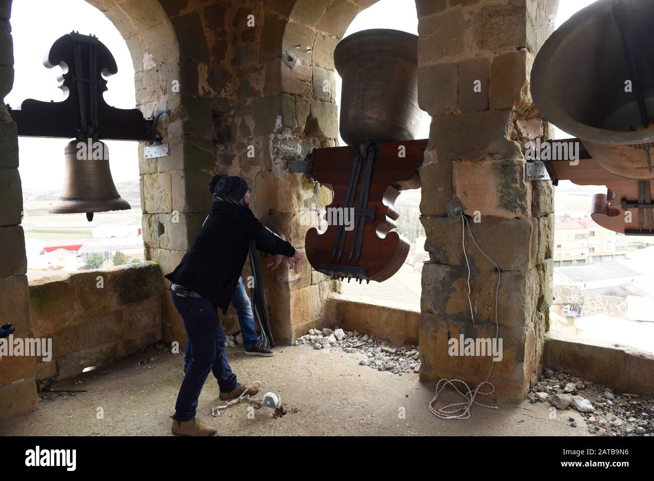A man rings a bell inside a church tower during the protest in Gómara
