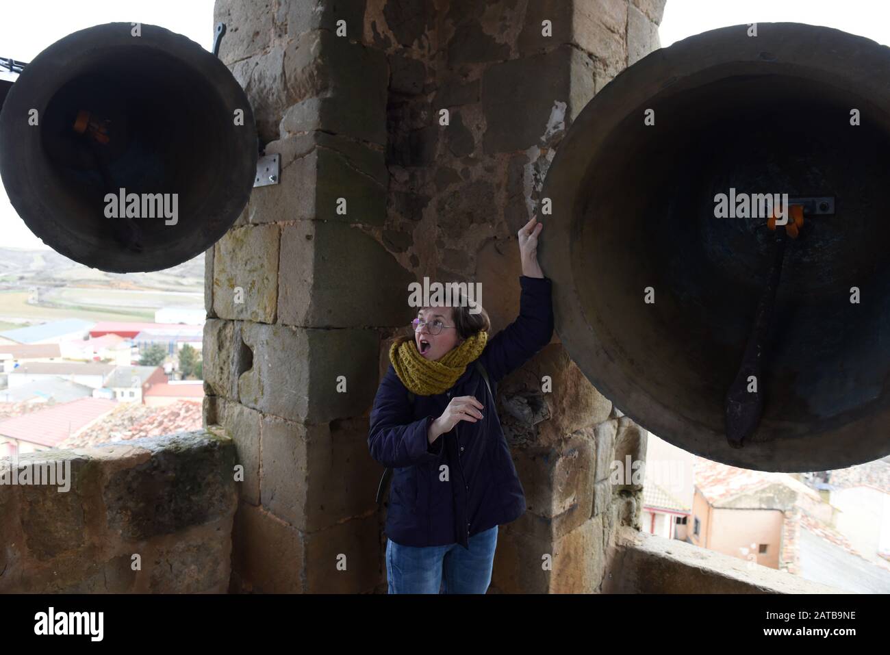 A woman rings a bell inside a church tower during the protest in Gómara