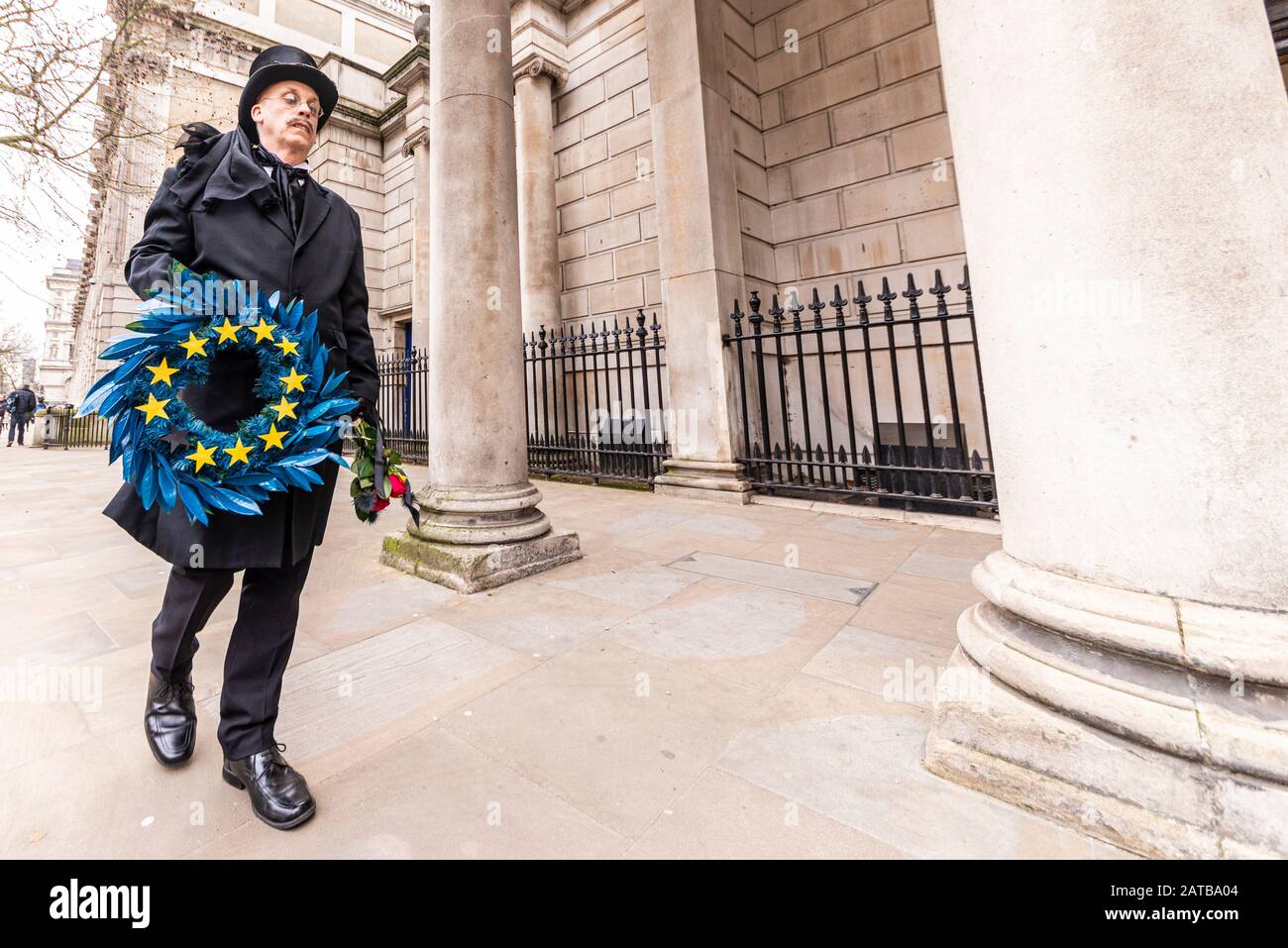 White male in funeral attire carrying a wreath in European Union flag colours mourning exit from EU on Brexit Day, 31 January 2020, in London, UK Stock Photo