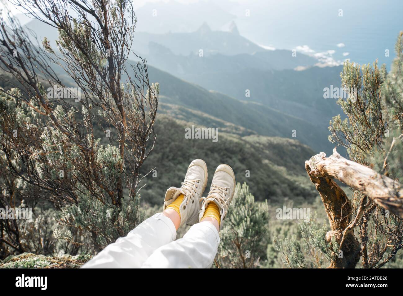 Girl sitting on cliff top hi-res stock photography and images - Alamy