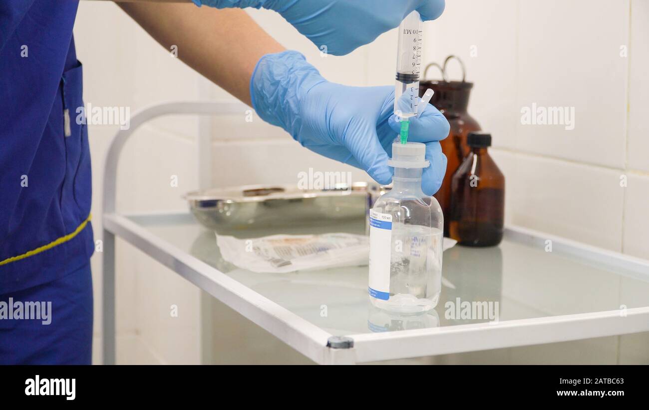 The doctor prepares a syringe with an injection and saline solution Stock Photo Alamy