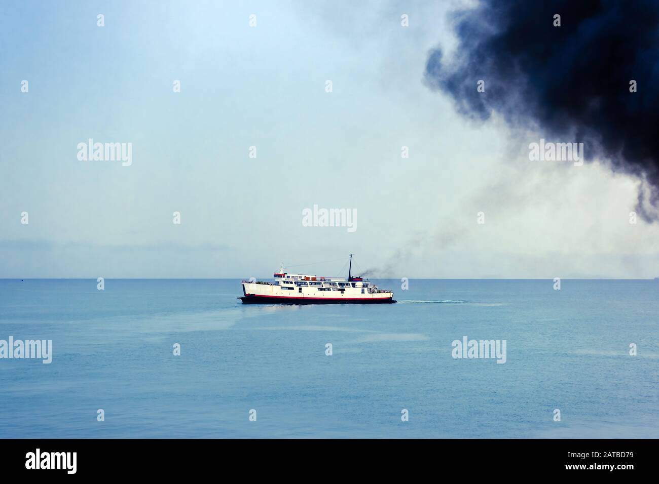 Exhaust pipe of ferry boat with black thick smoke coming out and sky ...