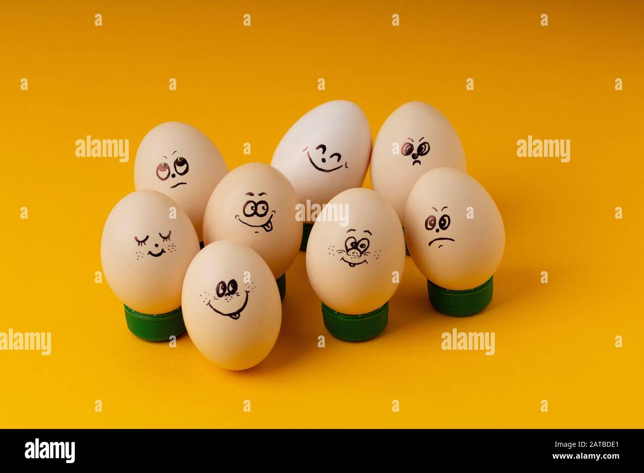 Chicken Eggs With Smileys For Easter Painting on yellow background . Happy Easter concept Stock Photo