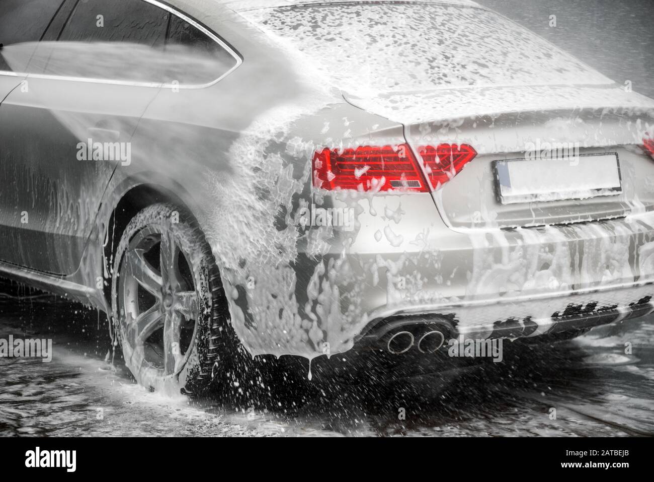 Washing grey car under high pressure water outdoors. - Back headlights in the focus Stock Photo