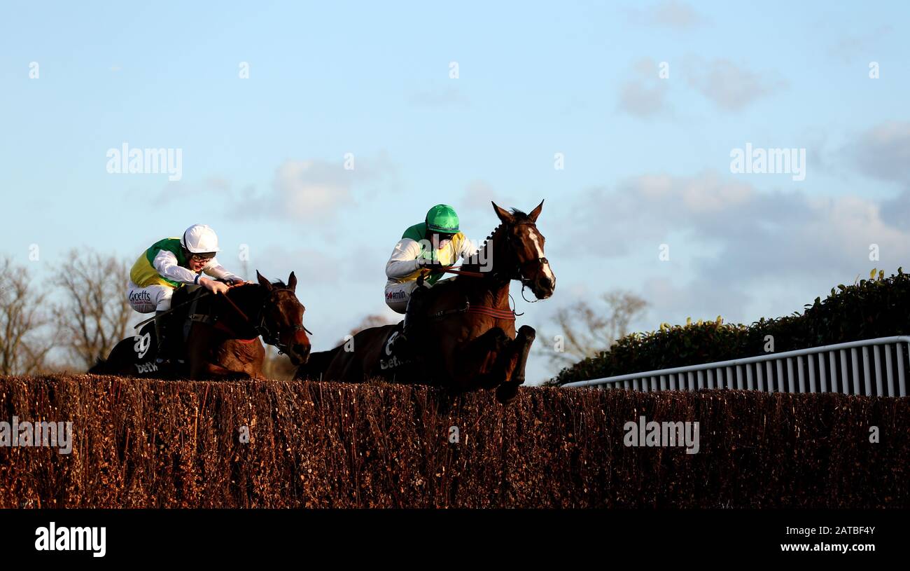 Deise Aba ridden by jockey Tom O'Brien goes onto win as Cloudy Glen ridden by jockey Charlie Deutsch (2nd place) in the Betway Masters Handicap Chase at Sandown Park Racecourse, Esher. Stock Photo