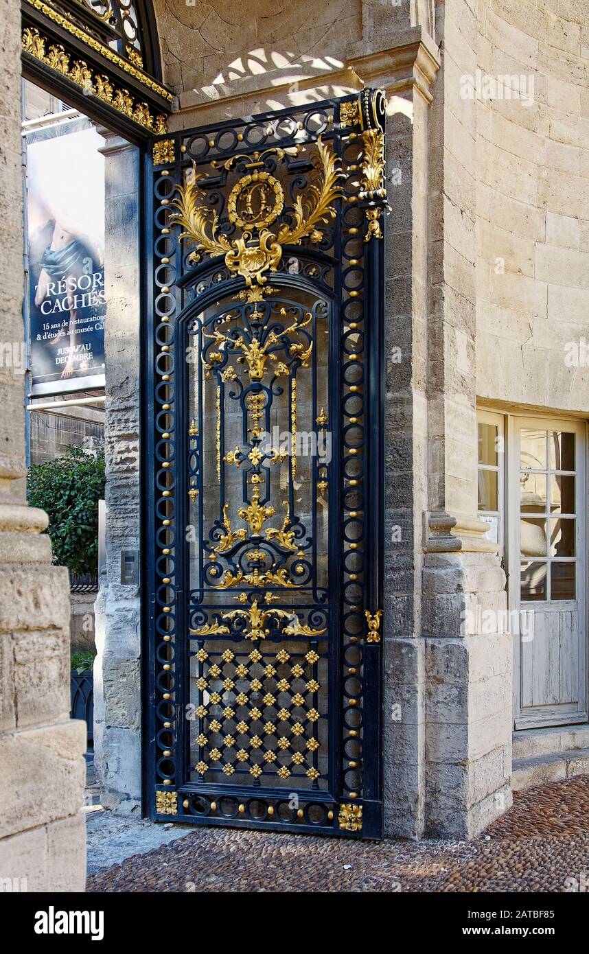 ornate iron gate, black, gold, entrance, Calvet Museum, courtyard, 18 century mansion, art, old stone building, Provence, Avignon, France, summer, ver Stock Photo