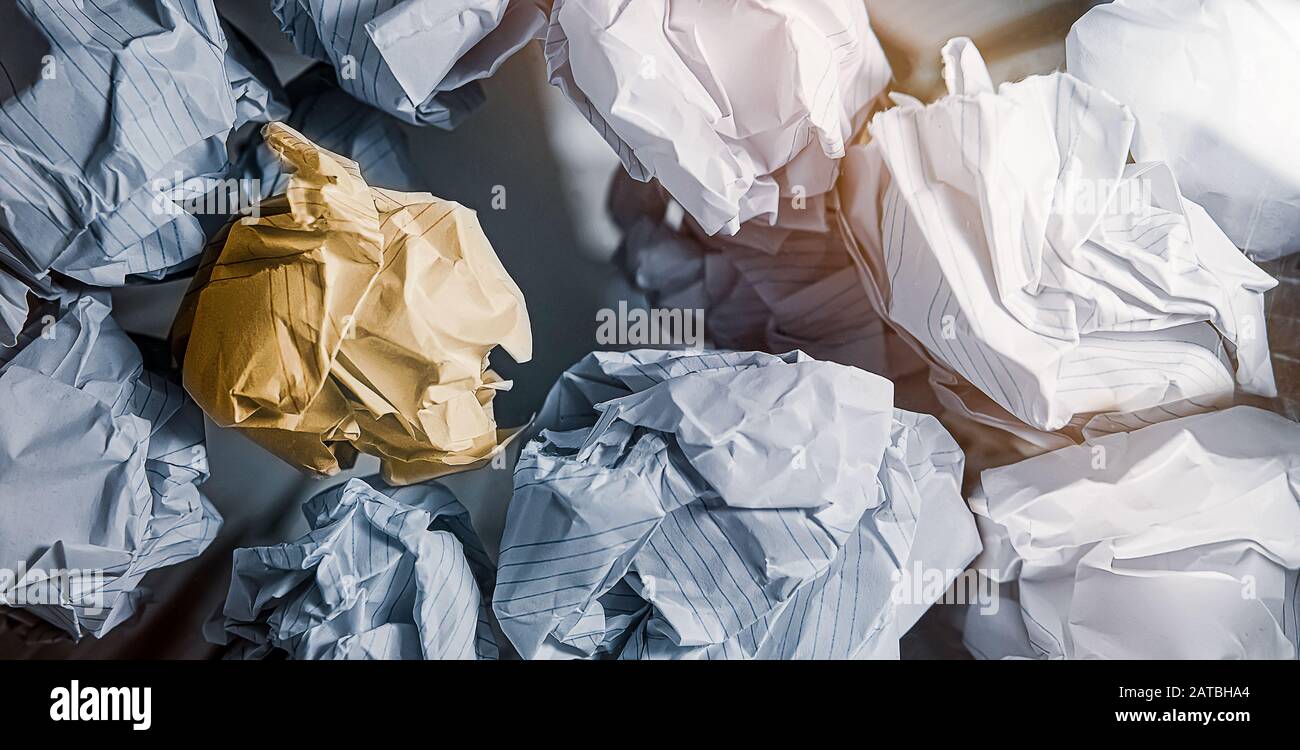 Crumpled paper in the trash can. One of them is a good idea. Bottom view, Idea concept. Stock Photo