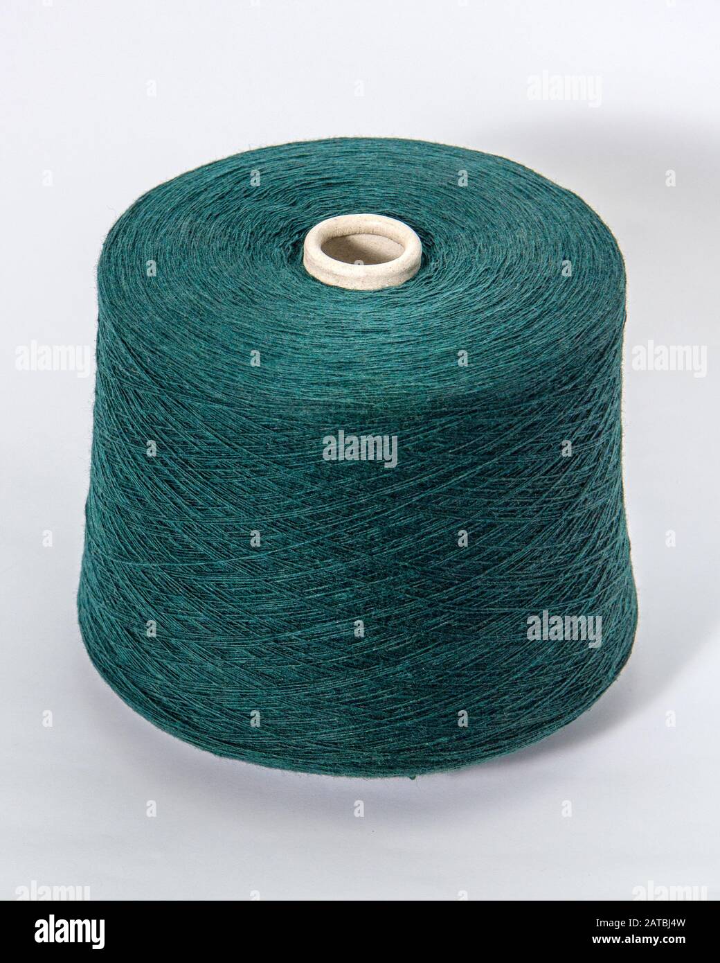 bobbin of yarn on a white background. Side view.Textile reel on