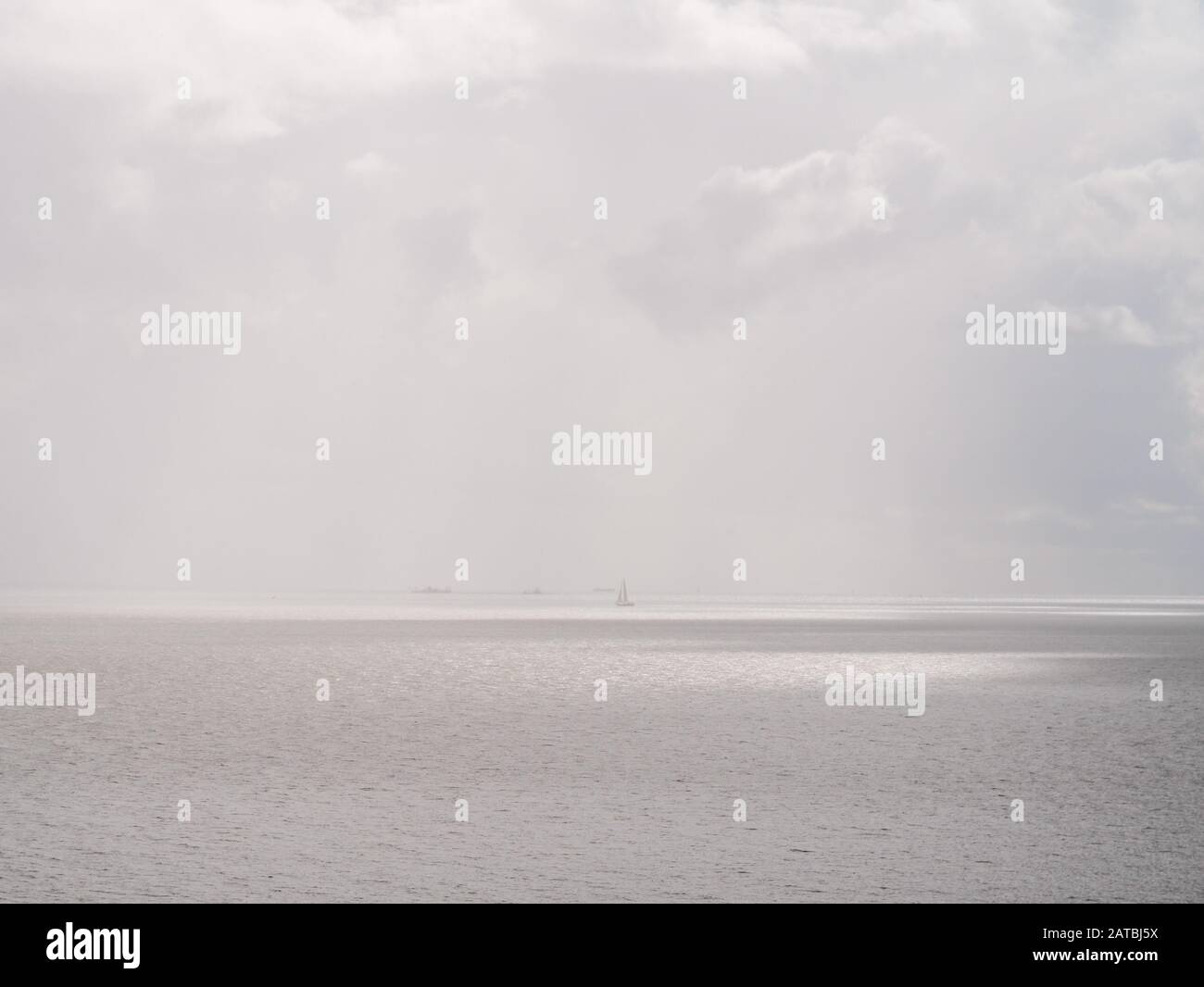 Hazy panoramic view over Markermeer lake with sailing boat, Netherlands Stock Photo