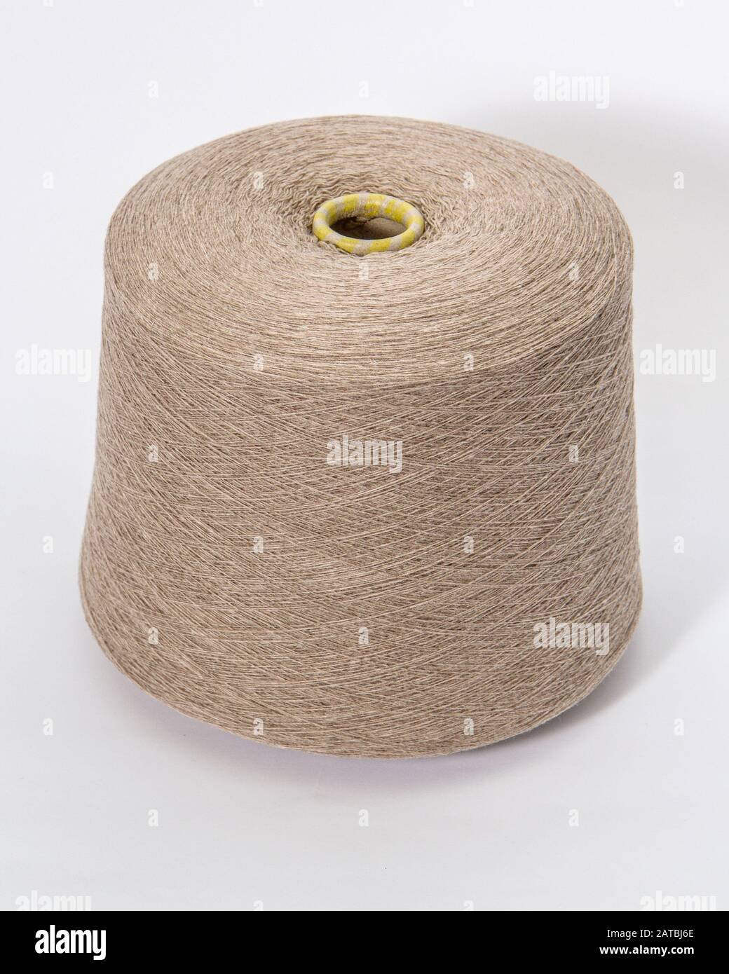 bobbin of yarn on a white background. Side view.Textile reel on